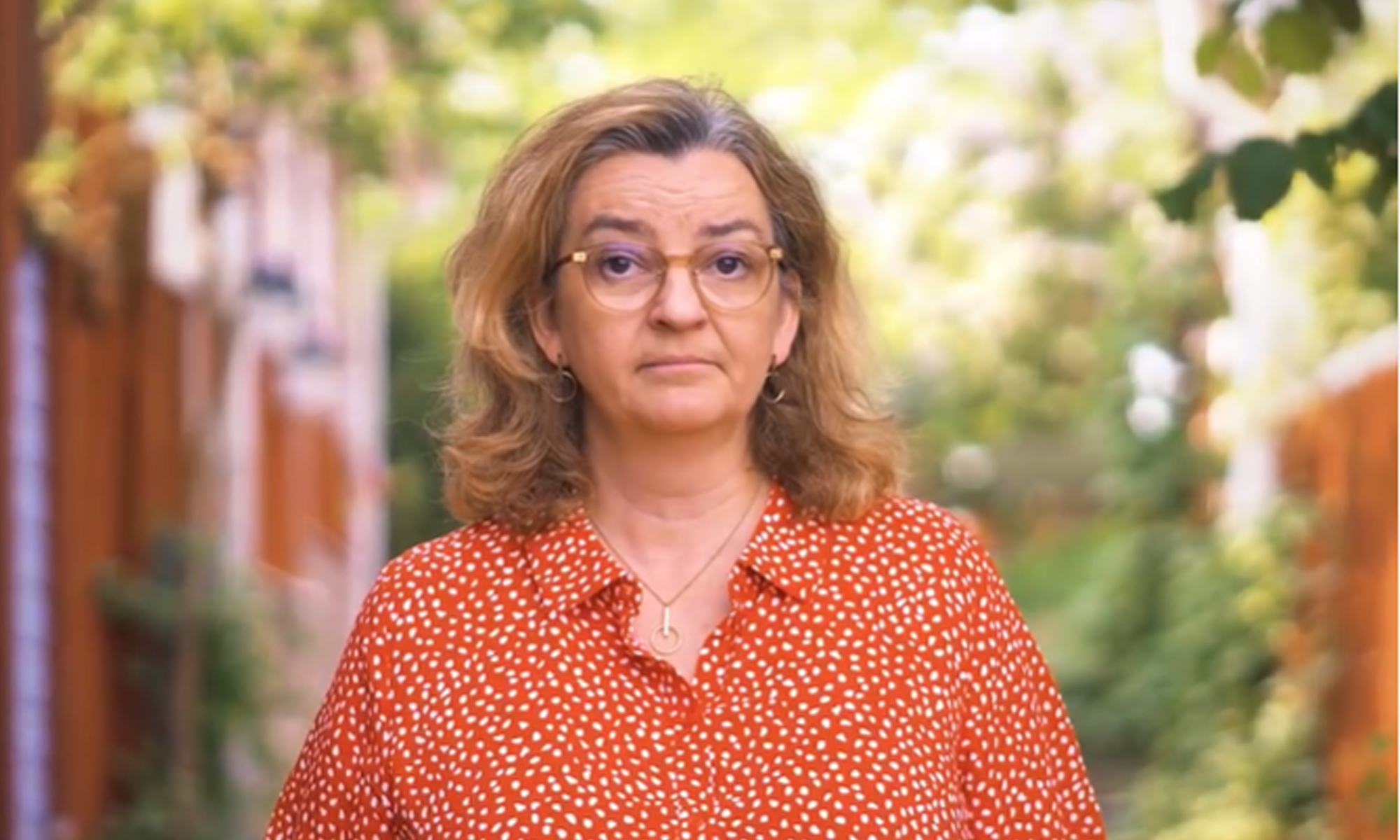 A serious woman looking in to the camera on a sunny day